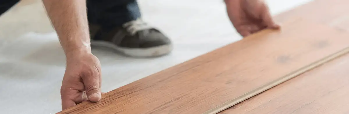 A professional installing laminate flooring in Bradenton, FL